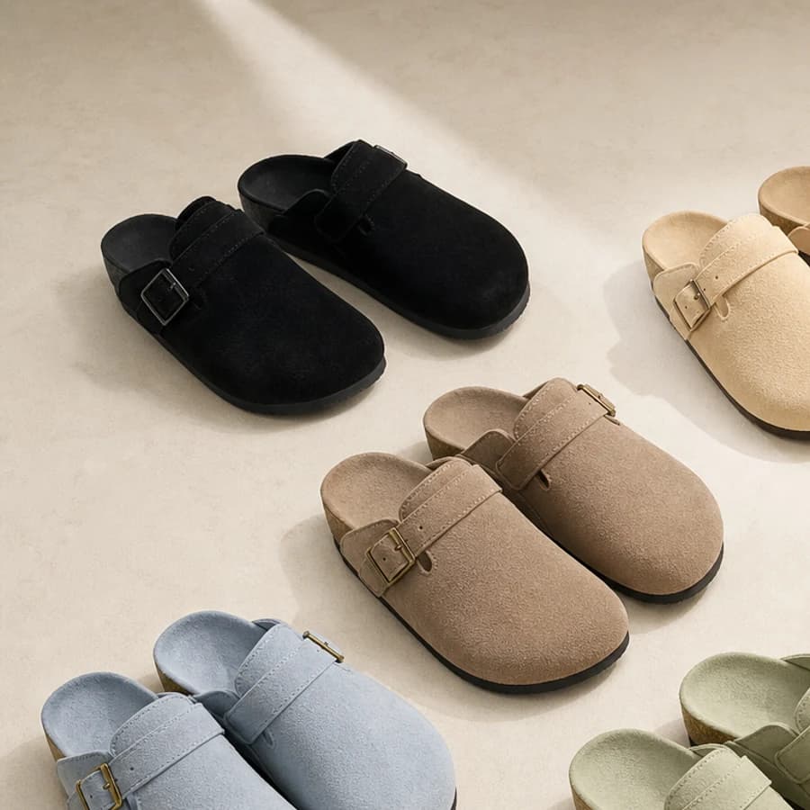 Neutral suede buckle clogs styled on warm ivory